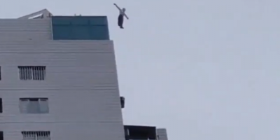 A Guy Falling Off A Tall Building In China.