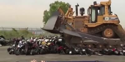 Bulldozer crushes illegal dirt bikes in NYC.