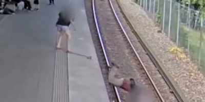 Insane Woman Pushes Elderly Man Onto The Train Tracks.