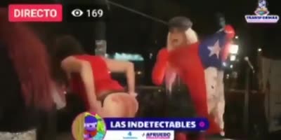 Transsexuals take national flag out of an ass during closing of electoral campaign in Chile