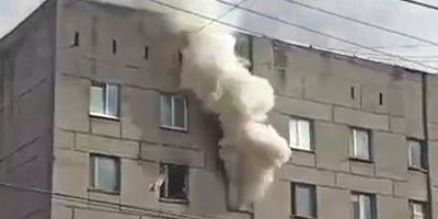 Woman Survives Jump Out of Burning Building