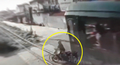 FAIL: Vietnamese Biker Tries to Beat a Train