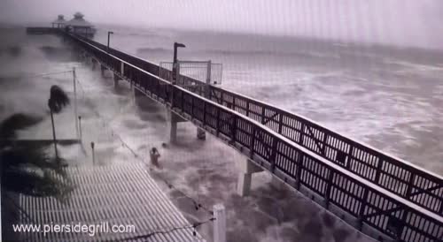Florida:  swimmers getting into the storm surge as Hurricane Ian approaches