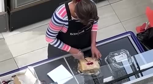 The saleswoman tries the cakes before selling them