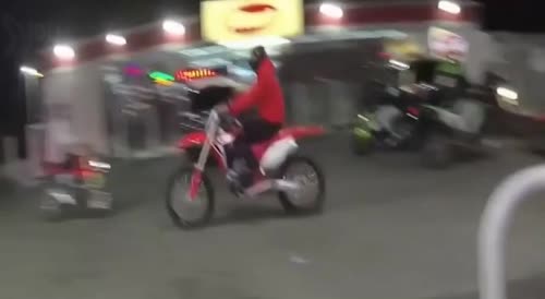 Mob on dirt bikes surround cops and hit police car with a brick