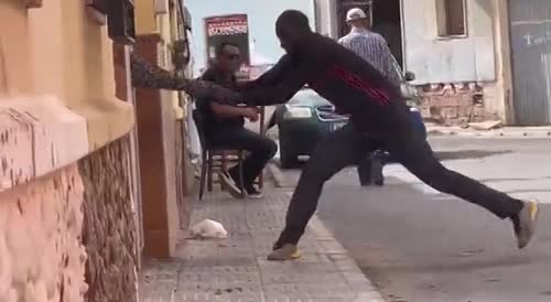 Spain: woman struggle to free herself from a brute as two men watch and another records