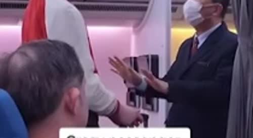 Two angles: Rude passenger frogmarched off plane after yelling at flight attendant