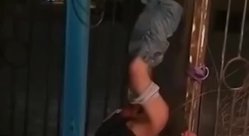 Drunken Russian hangs half-naked from the fence