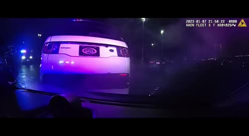 Suspect drives onto police car hood