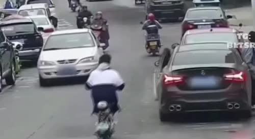 Poor man on a scooter gets tossed around like a ping pong ball.
