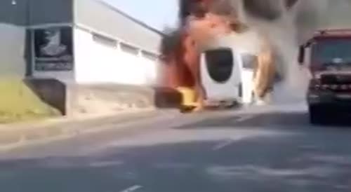 Burning bus rolls down street to crash into other cars.