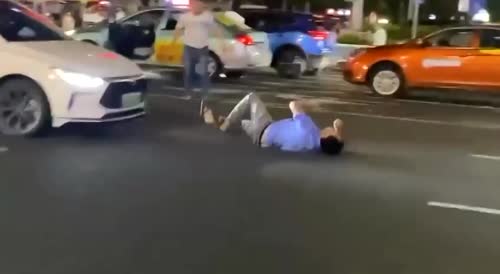 Idiots tussle in middle of street... but one gets hit by car