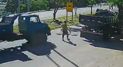 Guy Taking A Stroll Crushed Between Trucks