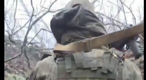 Russian soldiers walk on Ukrainian corpses