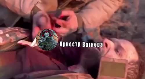 A Ukrainian soldier wounded by a shrapnel in the chest, screams in pain