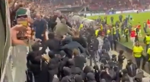 Sports: 2 West Ham fans managing to stop a mob of AZ Alkmaar fans