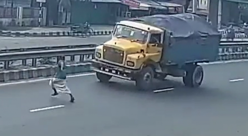 Man Tries to Stop Truck Unsuccessfully