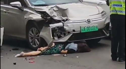Woman Pancaked Between Two Cars
