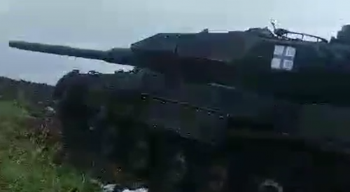 The Russian army examines the corpses of Ukrainians near the wrecked Leopard tank
