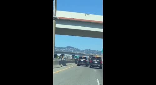 Another Angle Of of  Naked Woman Firing A Gun Shuts Down Highway In Oakland