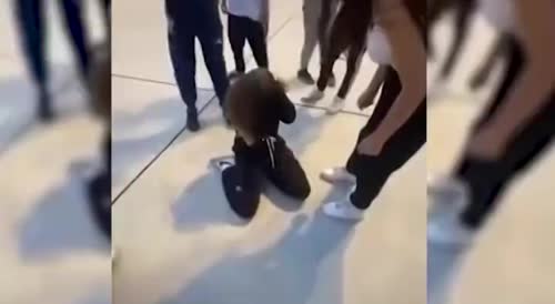a girl being beaten by a group