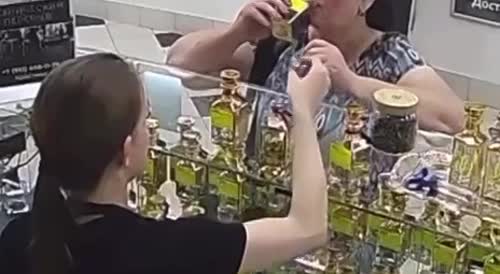 Woman Sips From A Fragrance Bottle Thinking Its Vodka