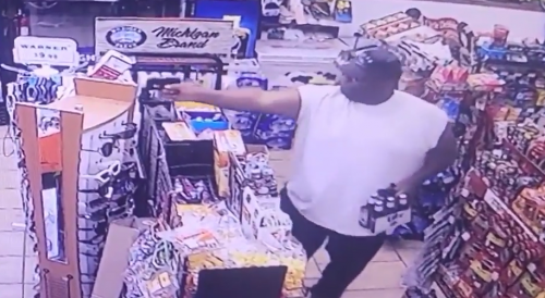 Customer guns down robber while holding a six-pack of Miller Lite beer