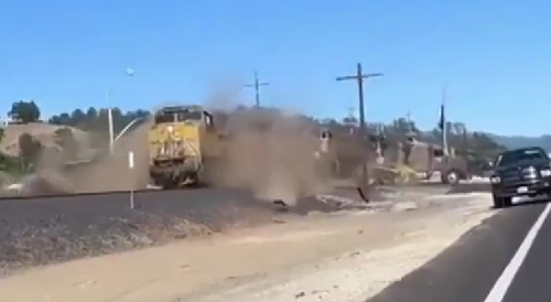 Train Demolishes Front Loader Stuck on Tracks
