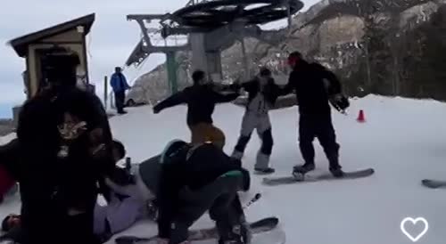 Snow Boarders Fighting at the Top of the Slope