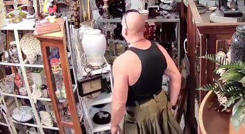 Man putting items up kilt at Spring antique mall