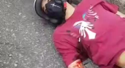 Laying on the street in agony