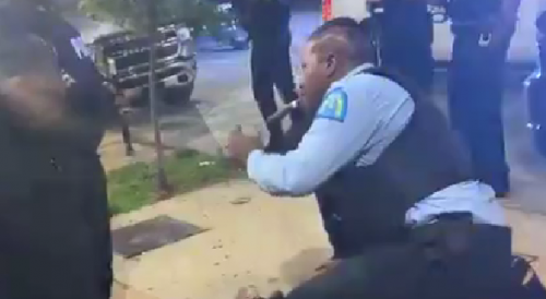 SLMPD officer lighting cigar while arresting man