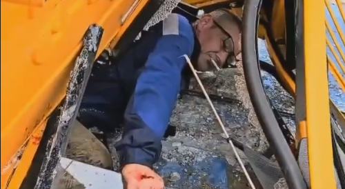 Fallen Crane Operator Asks For A Lighter In Dagestan, Russia