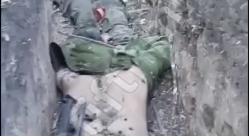Russian soldier walking over the corpses of the Ukrainians who tried to kill him.