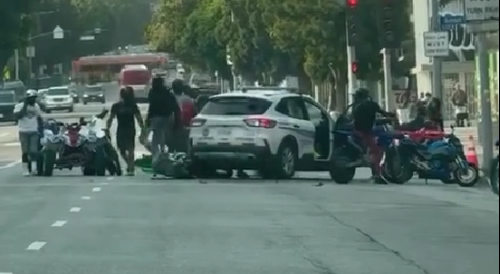 Group of bikers attacking security guard's car in Hollywood after he hit one of them