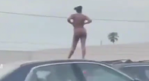 Nude woman standing atop SUV on busy L.A. freeway