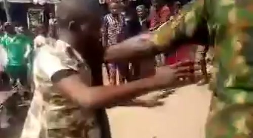 Nigerian Soldiers Beating Young Man In Public For Wearing Camouflage