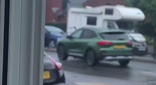 Road rage. Man hits car with a pole