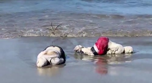 Waves wash up two bodies tied up and anchored on this beach in Mexico