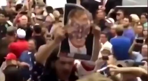 Antifa Heckled Trump at a Rally with a Picture of Him as Hitler