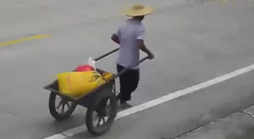 Dude with wheelbarrow gets wiped out by car