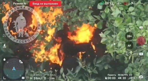 Setting fire to another wounded Ukrainian.