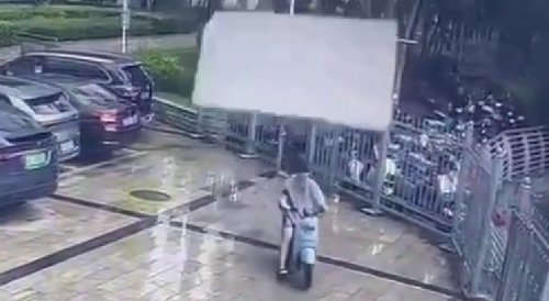 Piece of a board Strikes scooter rider During a Typhoon