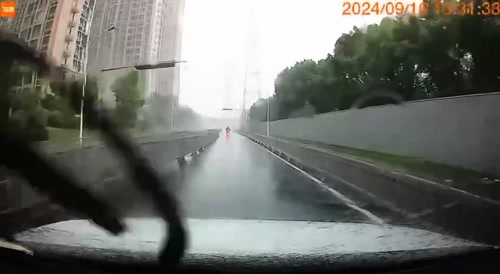 Heavy Winds Blew Piece Of Billboard Into Biker