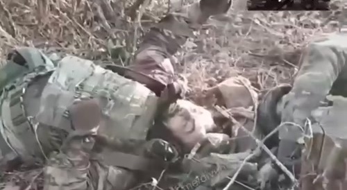 Finishing off a dying Ukrainian soldier in the head and taking a prisoner