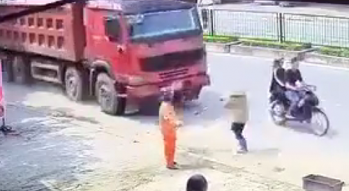 Woman Cleaning The Road Knocked Out By Truck