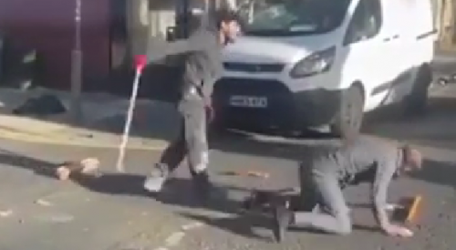 Men batter each other with metal poles in the middle of the road in the  UK