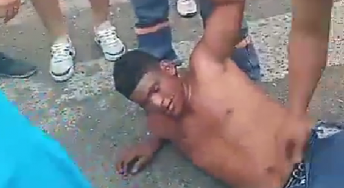 Angry Citizens Kick Captured  Phone Thief In Ecuador