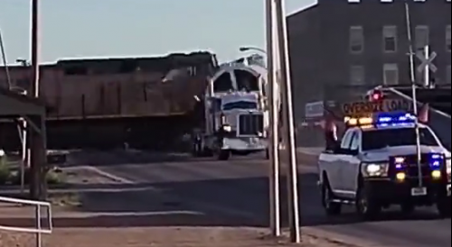 Train versus tractor trailer carrying oversized load; truck wins this one