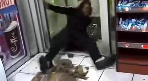 An angry man (in a store) receives a bag of ice in the head